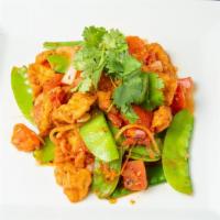 Tofu Country Style - Đậu Om Cà Chua · Fried tofu sautéed with tomatoes, white onions and snow peas, in spicy red sauce, served wit...