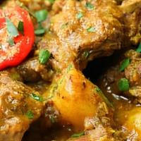 Curry Goat · Slow-cooked chunks of goat meat spiced with flavorful curry.