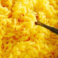 Yellow Rice · Non-spicy rice simmered in special Caribbean seasonings.