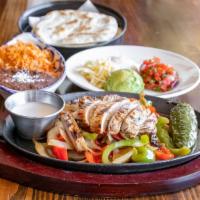 Fajitas · served sizzling with onions & peppers, frothy garlic butter