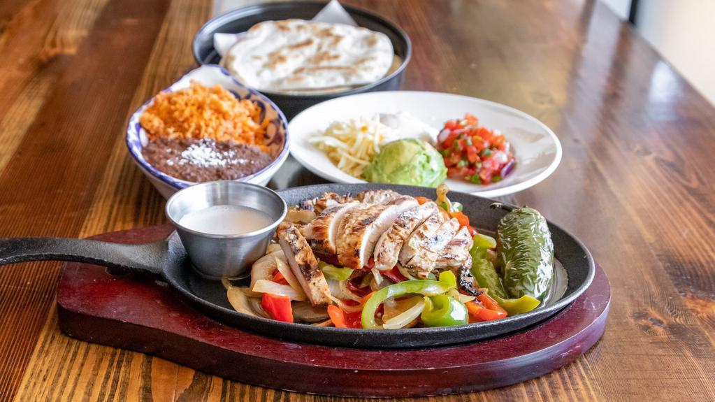 Fajitas · served sizzling with onions & peppers, frothy garlic butter