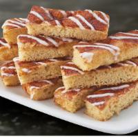 Cinnamon Stix (12 Pcs) · 130 cal. Freshly baked pizza dough with butter, cinnamon sugar and topped with vanilla icing.