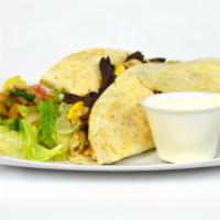 Baleadas Con Carne · Flour tortilla stuffed with cheese, black beans, pan-fried eggs, and grilled steak served wi...