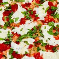 Margherita Pizza (Round) · Fresh mozzarella, margherita sauce & basil on a round crust pizza
