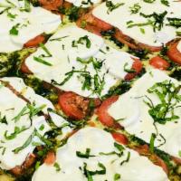 Grandma Pesto Pizza · Fresh mozzarella, tomatoes & homemade pesto on a thin sicilian crust. (Nut allergy safe pesto)