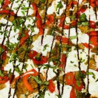Eggplant Roselli Pizza · Breaded eggplant, fresh mozzarella, roasted red peppers and balsamic glaze drizzle.