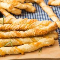 Cheese Breadsticks · Fresh fluffy sticks of bread topped with cheese.