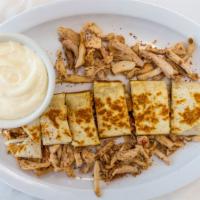 Chicken Shawarma With Garlic Sauce · Seasoned meat cooked on a rotisserie.