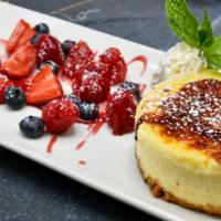 Ny Cheesecake · Bruleed Sugar Crust, Seasonal Berry Compote, Whipped Cream.