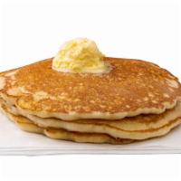 Buttermilk Pancakes · Three cakes, strawberries or blueberries.