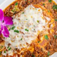 Meat Lasagna · Thin layers of pasta baked with béchamel
and meat sauce.