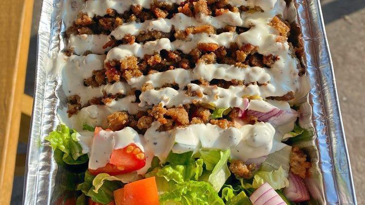 Gyro Plate Over Rice · A combination of ground beef and lamb slowly roasted on a vertical pit, thinly sliced. Served with garlic sauce and hot sauce.