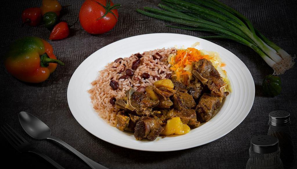 Goat Dinner · Goat morsels stewed in our savory curry sauce, served with rice and peas and a side of cabbage