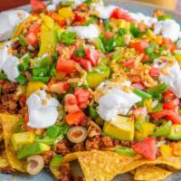 Combo Nacho Supreme · Delicious bean and cheese nachos with your choice of ground beef and shredded chicken, a sid...