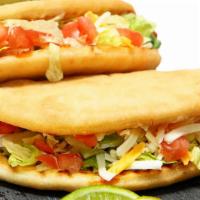 Beef Chalupa · Delicious beef chalupa topped with lettuce, tomatoes, cheese, and sour cream.