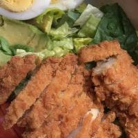 Fried Chicken Cobb Salad · Romaine lettuce topped with fried chicken, bacon, tomatoes, avocado, hard-boiled egg, and bl...
