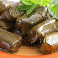Dolma · Grape leaves stuffed with rice, tomatoes, onions and parsley slow-cooked with lemon juice an...