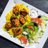 Chicken Kabob Plate · Skewers of marinated chicken tenders, charbroiled on an open fire served with rice, Greek sa...