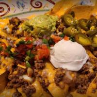 Fajita Nachos · Fajita chicken or fajita beef with refried beans and mixed cheeses. Served with the works.