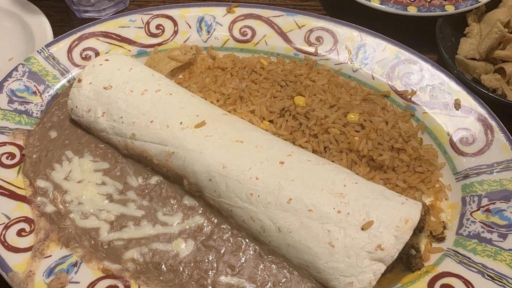 Beef Burrito · Taco beef, mixed cheeses and pico de gallo wrapped in a flour tortillaand topped with chile con carne and mixed cheeses. Served with Mexican rice and refried beans.