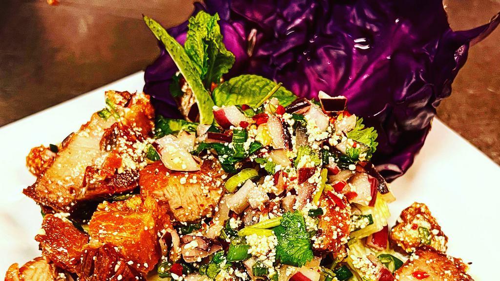 S3: Crispy Pork Belly Salad · House crispy pork belly, roasted rice powder, mint, shallot, green onion, cilantro mixed with lime dressing served with spring mix.