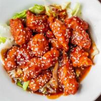 Sesame Chicken · Breaded chicken cooked in a sweet sauce with sesame seed, and served over a bed of crisp ice...
