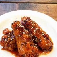 Sweet And Spicy Wings · Four pieces Chicken wing dings marinated in our special sauce, deep fried, and seared in a t...