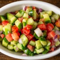 Shirazi Salad · Diced tomato, red onions, cucumber, parsley topped with lemon juice and olive oil.