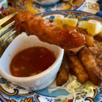 Calamari Strips · Tender strips of breaded squid deep-fried to golden brown perfection served on a bed of lett...