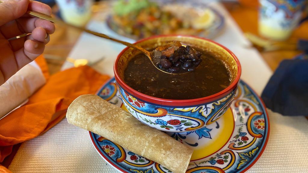 Black Bean Soup · Traditional black beans soup with tomatoes, onions, and cilantro. Served with 2 tortillas.