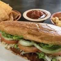 Carne Asada Torta · Steak seasoned with our house spices, mayo, guacamole, lettuce, slices of tomatoes, and onio...