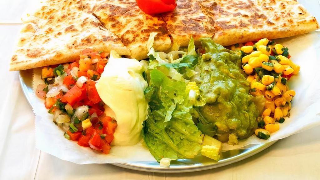 **Baja Quesadilla** · Grilled White or Wheat Flour Tortilla with cheese and choice of Meat. Choice of sides: lettuce, pico de gallo, corn salsa, sour cream, guacamole.