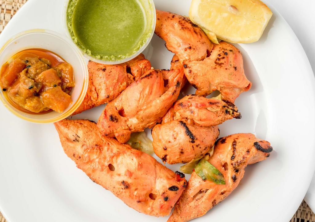 Chicken Tikka · Boneless strips of chicken breast marinated in yogurt, herbs and spices. Roasted in special clay oven. Tandoor.