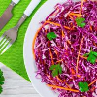 Tangy Red Cabbage Slaw · Red cabbage and carrots are mixed with a sweet and tangy dressing for a fresh and delicious ...