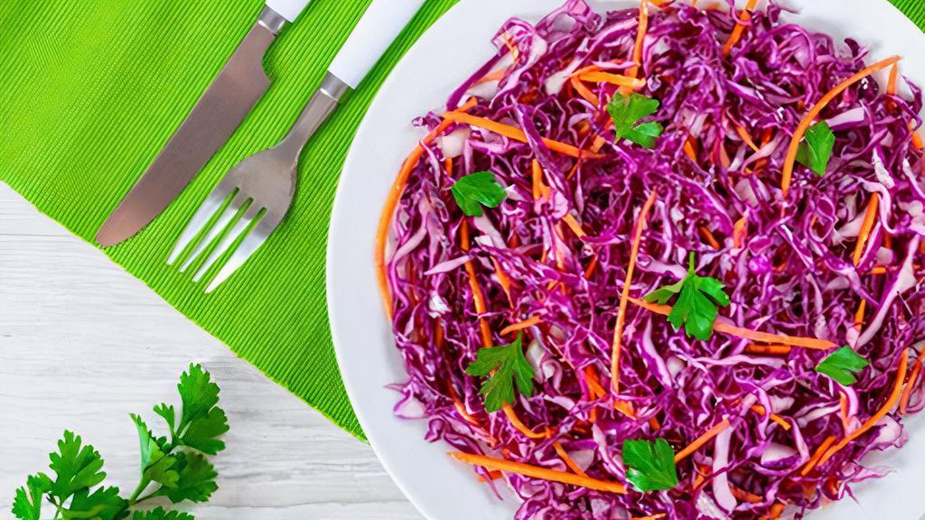 Tangy Red Cabbage Slaw · Red cabbage and carrots are mixed with a sweet and tangy dressing for a fresh and delicious complement to any dish.