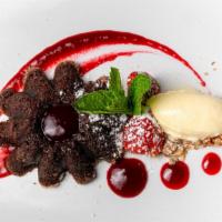 Warm Molten Chocolate Cake · Raspberry puree, house made vanilla ice cream, walnut crumbles.