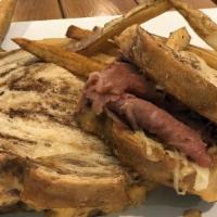 Rye Reuben · Grilled corned beef, sauerkraut, 1000 island and melted swiss. Served on freshly baked marbl...