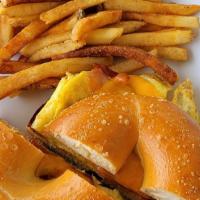 Breakfast Sandwich · Served with two eggs, applewood smoked bacon or grilled ham, with cheddar cheese on a toaste...