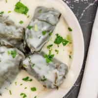 Dolmades Avgolemono · Stuffed grape leaves. Grape leaves stuffed with beef, rice and mint topped with an egg lemon...