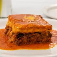 Moussakas · Moussaka. Layers of eggplant, potatoes, and seasoned ground beef topped with bechamel sauce ...