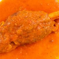 Kapamas · Braised lamb shank. Slowly braised lamb shank in a tomato and vegetable blend seasoned with ...