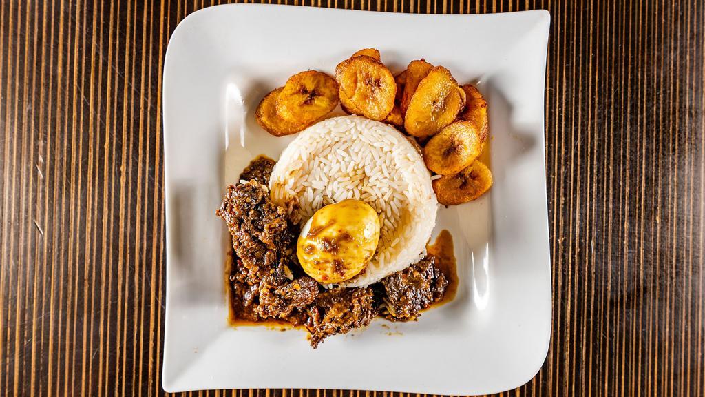 Designer Rice Meal  · Spicy stew fried in palm oil and served with assorted meat, boiled egg, white rice, and plantains