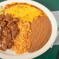 Plato Tejano · A favorite Tex-Mex plate: carne guisada and cheese enchilada served with rice, beans, salad ...