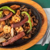 Parrillada Arandas · An assorted platter of beef fajitas, chicken fajitas, country sausage and shrimp grilled in ...