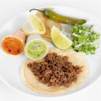 Tacos · Corn or flour tortilla with cilantro and onions, grill onions, jalapeño, and lime on a side.