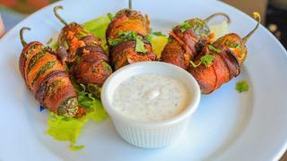 Stuffed Jalapeños · Five cream cheese stuffed jalapeños wrapped in bacon. Served with habanero jelly.