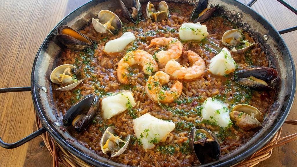 Paella De Mariscos · saffron-seafood stock, cod/halibut, mussels, clams, shrimp, sofrito, picada sauce