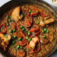 Paella De Pollo & Chorizo · vegetable stock, braised chicken, chorizo, bell peppers, peas, picada sauce
