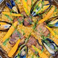 Paella De Mar Y Montaña · vegetable stock, pork coppa, mussels, roasted carrots, sofrito, picada sauce