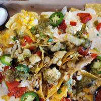 Veggie Verde Nachos · White queso, cheddar jack & Cotija cheeses, fire-roasted red peppers, fresh jalapeños, sour ...